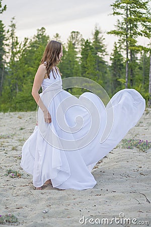 Beautiful girl dancing on the beach. Stock Photo