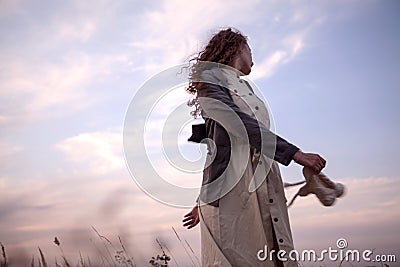 Beautiful girl dancing outside, sky is a background Stock Photo