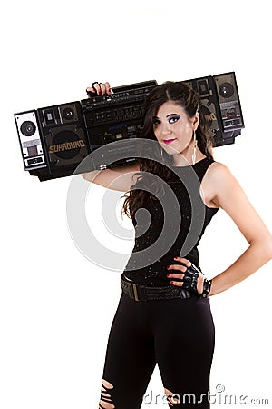 Beautiful girl in dark leather clothes holding a large retro radio Stock Photo