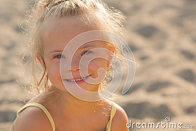 Beautiful girl with Down syndrome on the beach Stock Photo