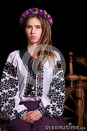 Modern Ukrainian national clothes. Portrait of a beautiful woman with dreadlocks in an embroidered national dress on a black Stock Photo
