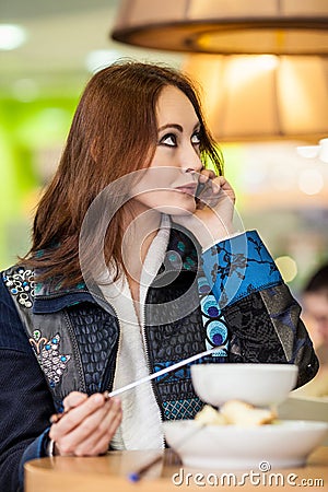 Beautiful girl eats chocolate fondue Stock Photo
