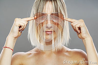 Beautiful girl fashion portrait. Glasses and wavy hair Stock Photo