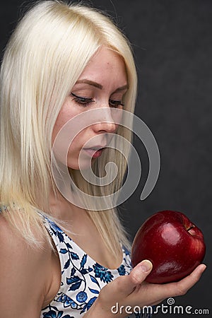 Beautiful girl in a fashionable dress with apple Stock Photo