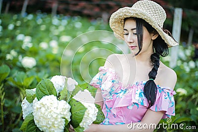 Beautiful girl with a field of hydrangea flowers Stock Photo