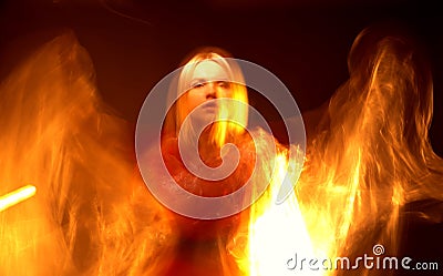 Beautiful girl with flame on black background Stock Photo