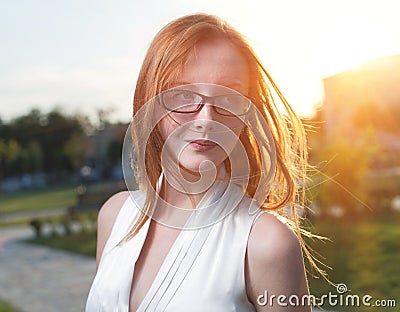 Beautiful girl ginger hair backlit by the sun Stock Photo