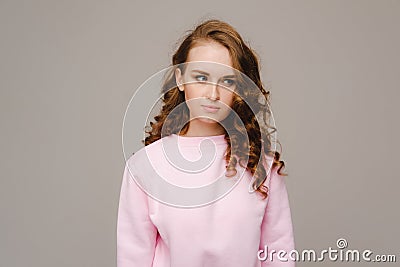 A beautiful girl on a gray background expresses her emotions, a woman with emotions Stock Photo