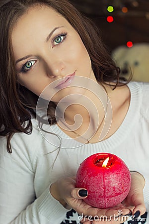 beautiful girl with green eyes with a red candle in his hand Stock Photo