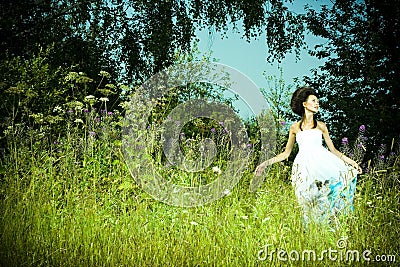 Beautiful girl in green meadow Stock Photo