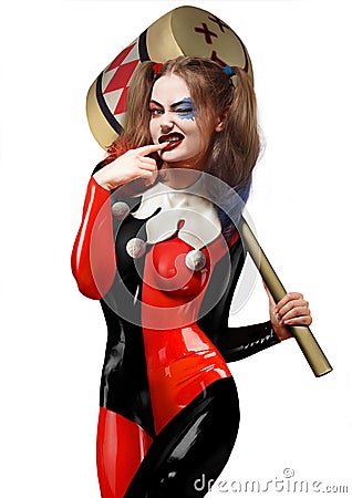 Beautiful girl in a Harley Quinn costume with a hammer in her ha Stock Photo