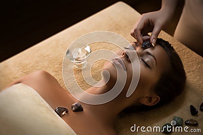 Beautiful girl has massage with chakra-stones Stock Photo