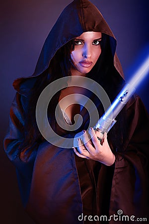 Beautiful girl holding a lightsaber Stock Photo