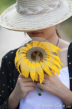 A beautiful girl holding a sunflower Stock Photo