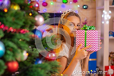 Beautiful girl hugged a treasured New Years gift Stock Photo