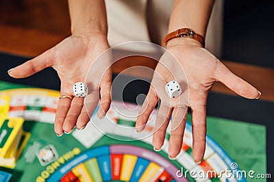 Beautiful girl invites you to play Business Strategy board game Stock Photo