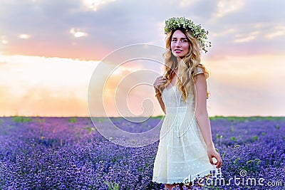 Beautiful Girl in lavender Field at sunset Stock Photo