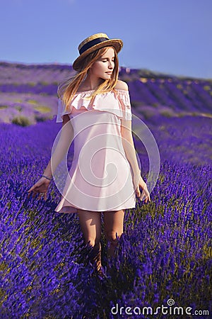 Beautiful girl on the lavender field. Beautiful woman in the lavender field on sunset. Soft focus. Provence, France. A girl in pin Stock Photo