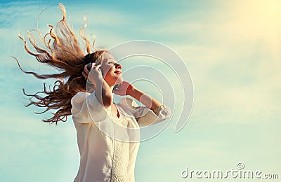 Beautiful girl listening to music on headphones Stock Photo