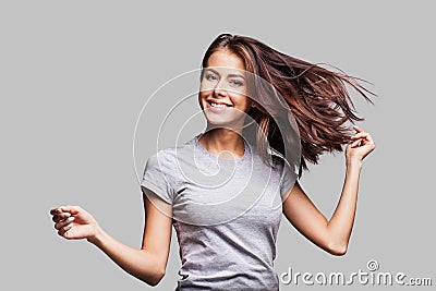 Beautiful girl with long hair laughing, dancing and enjoying life Stock Photo