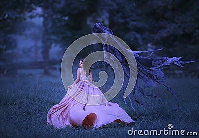 Beautiful girl in a long, pink, fluttering dress runs away from death in the form of a dark demon who came out of hell Stock Photo