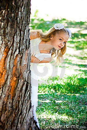 Beautiful Girl Looks From The Tree In The Park Stock Photo