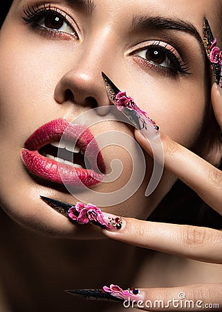 Beautiful girl in mask with long nails and sensual lips. Beauty face. Stock Photo