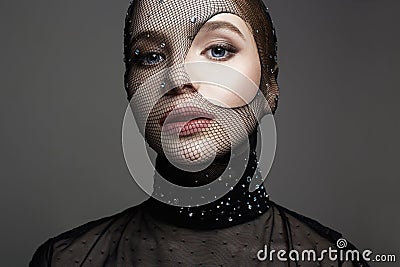 Beautiful girl in mask. Beautiful Woman in Net on her Face Stock Photo