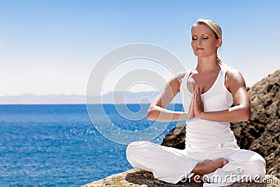 Beautiful girl meditating in yoga pose Stock Photo