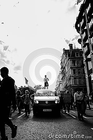 Beautiful girl with megaphone standing on the top of the van in front of the Huge crowd of Black Lives Matters protesters heading Editorial Stock Photo