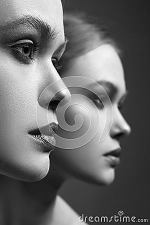 Beautiful Girl in mirror. Young woman and her reflection Stock Photo