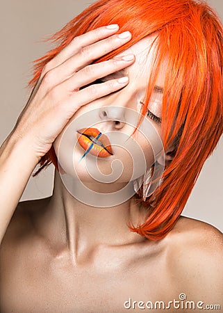 Beautiful girl in an orange wig cosplay style with bright creative lips. Art beauty image. Stock Photo