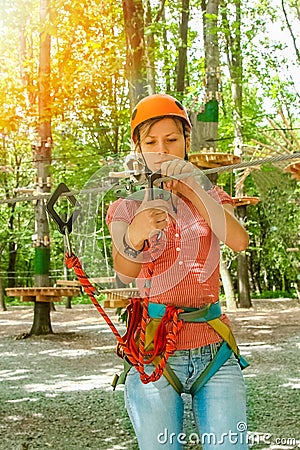 Beautiful girl in the park on the ropes achieve Outdoors Stock Photo