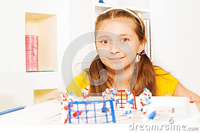 Beautiful girl playing ice hockey table board game Stock Photo