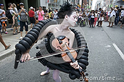 Beautiful girl playing the violin. Female violinist perform in a street festival Editorial Stock Photo