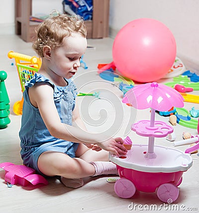 Beautiful girl plays toys Stock Photo