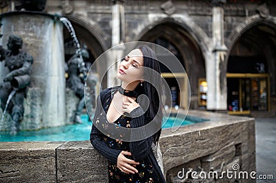 Beautiful girl portrait on the street in black dress Stock Photo