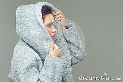 Beautiful girl posing in fashion stule, dressed gray coat with h Stock Photo
