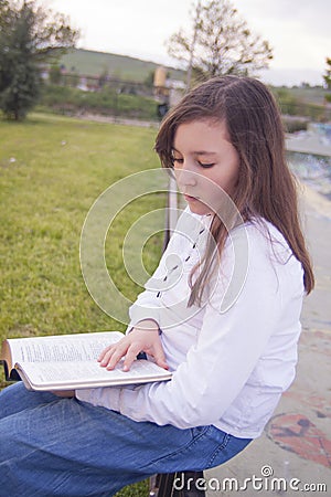 Beautiful girl reading a book Stock Photo