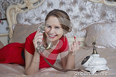 Beautiful girl in red dress talking on the phone Stock Photo