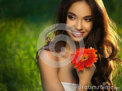 Beautiful Girl With Red Flowers. Beautiful Model Woman Face. Stock Photo