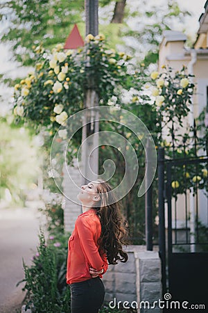 Beautiful girl in a red shirt posing on a street Stock Photo