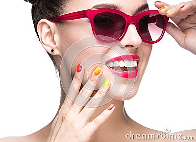 Beautiful girl in red sunglasses with bright makeup and colorful nails. Beauty face. Stock Photo