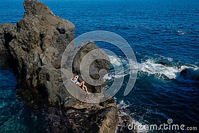 Beautiful girl resting in natural ocean swimming pool Stock Photo