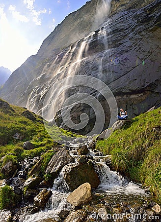 Beautiful girl resting near the Lauterbrunnen waterfall Stock Photo