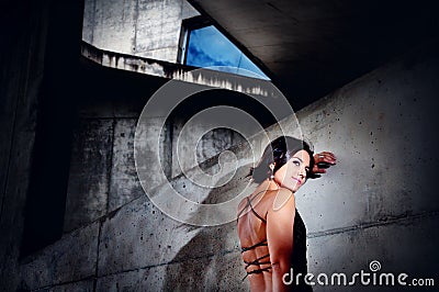 Beautiful girl rests against a concrete wall. Urban fashion, lifestyle Stock Photo