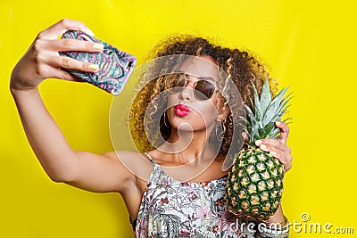 Beautiful Girl selfie with a smartphone. Beautiful young African American woman with afro hairstyle and sunglasses Stock Photo