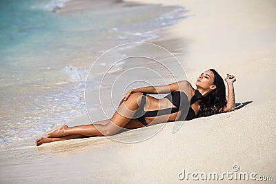 Beautiful girl in a bikini on the beach Stock Photo