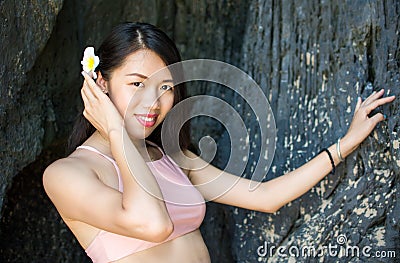 Beautiful girl in the shade of beach cave Stock Photo