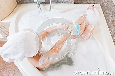 Beautiful girl showering and washing hands in bathtub. Stock Photo